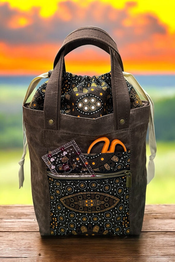 Firefly Tote by Noodlehead – versatile project bag with drawstring closure, interior slip pocket, and waterproof canvas exterior, featuring Aboriginal print fabric.